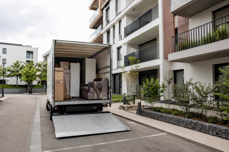 Résidence moderne avec parking et utilitaire hayon ouvert